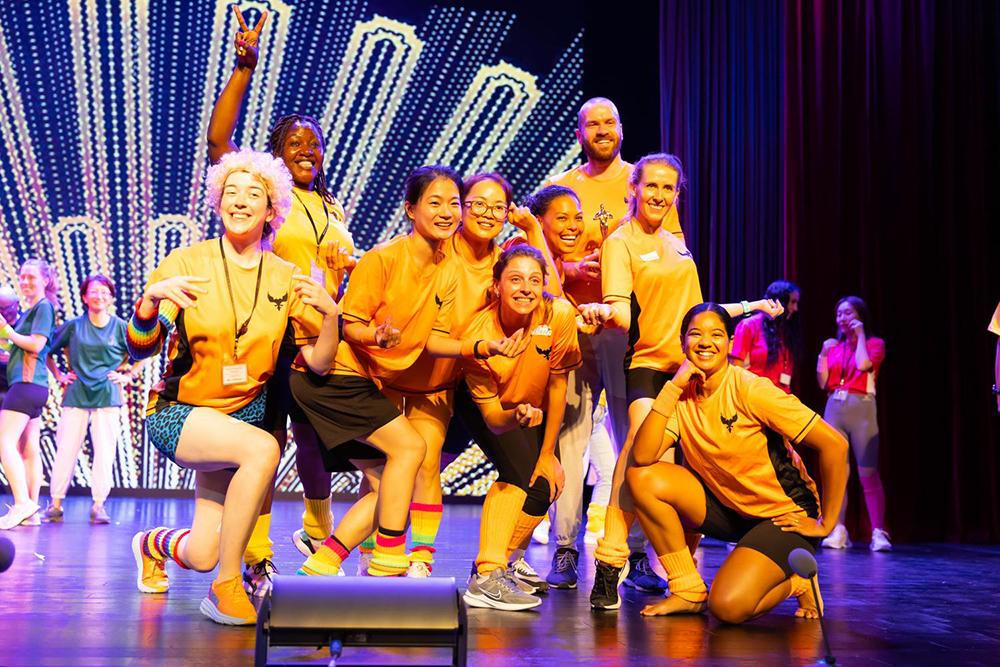 Teachers pose on stage after a performance, showcasing the vibrant community that teachers can expect to be a part of when they apply for a teaching job at Hiba Academy Bay Area, an international school in San Francisco.