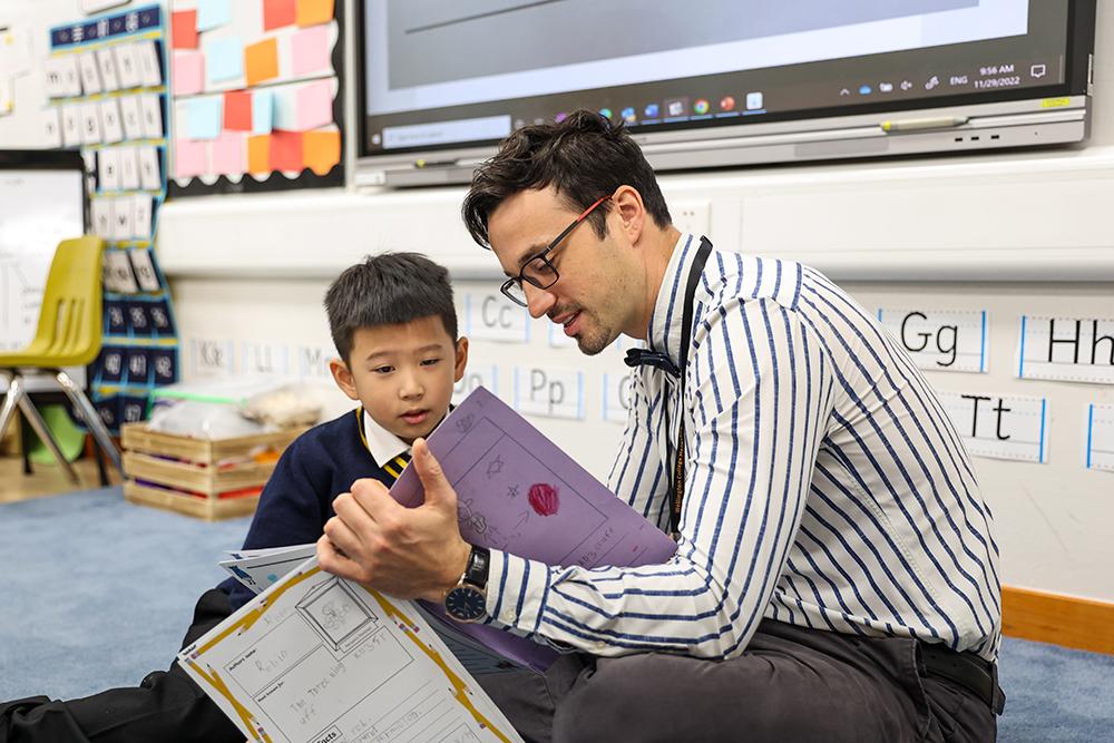 A teacher goes through a worksheet with a student at Hiba Academy Bay Area, a private international kindergarten in San Francisco Bay Area offering Early Years curriculum.