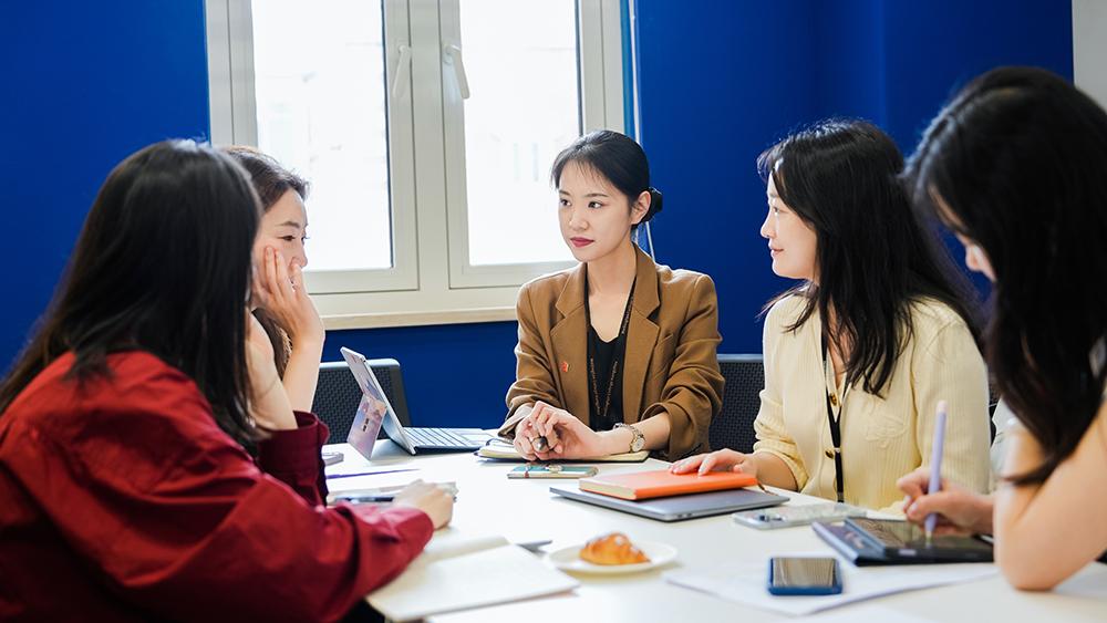 Teachers share learnings and tips at a meeting, reflecting the professional growth and career development opportunities available for teachers when they join Hiba Academy Bay Area, an international school in San Francisco.