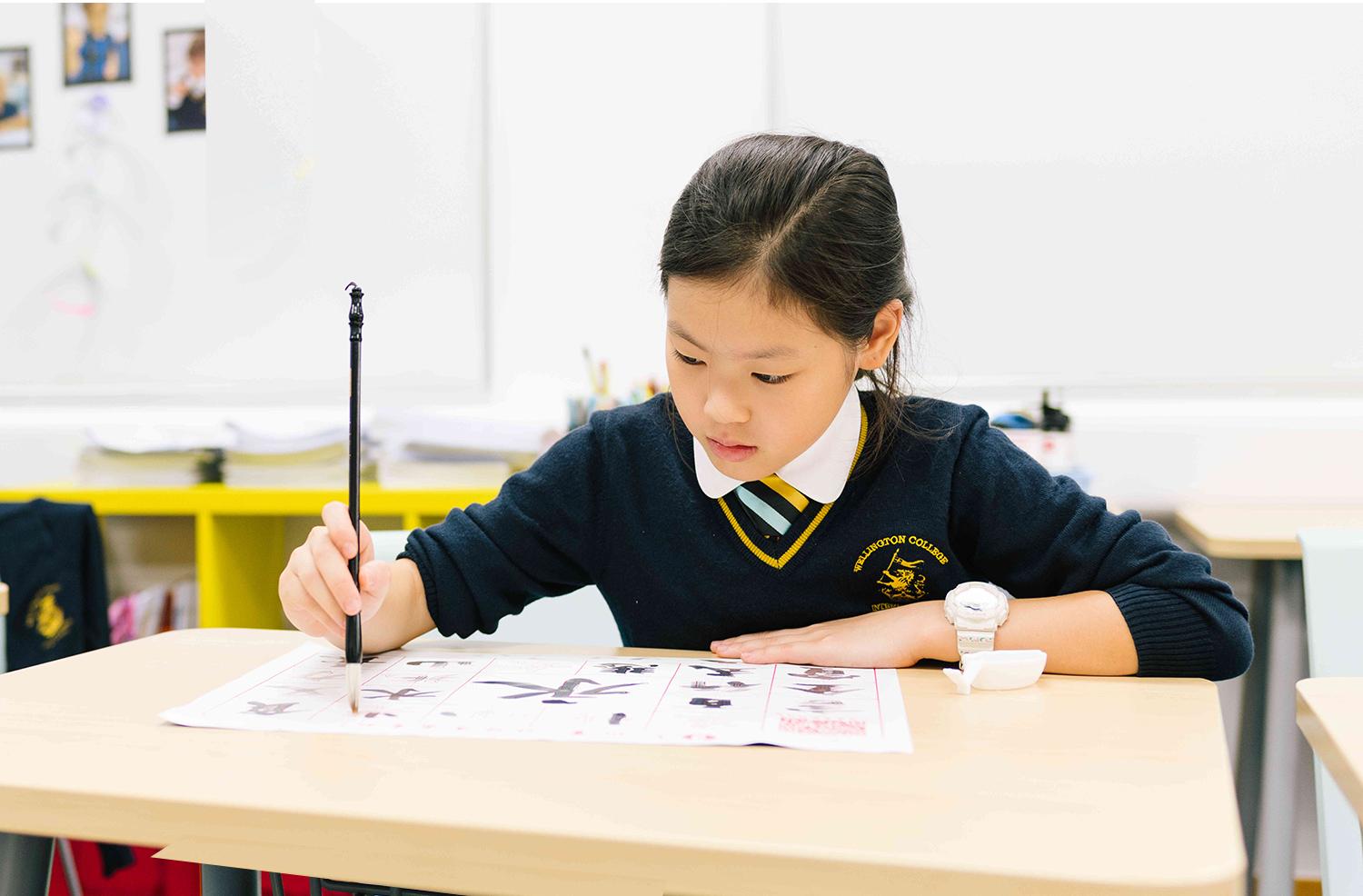 A young student practicing Chinese calligraphy as part of Hiba Academy’s immersive bilingual curriculum that encourages dual language learning by using both English and Chinese as languages of instruction across all subjects.