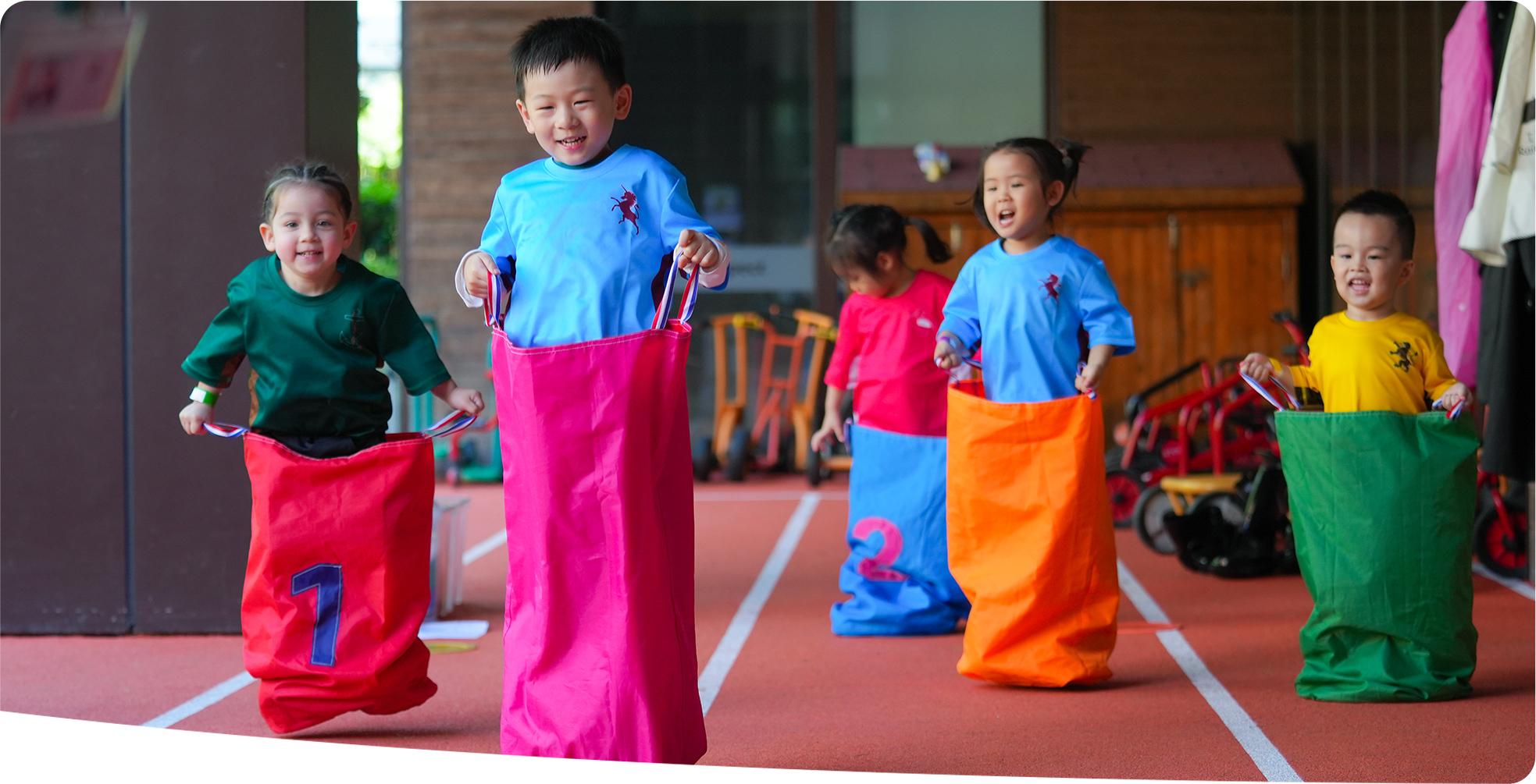 Students participating in a sack race, showcasing how the International Curriculum adopted by Hiba Academy addresses the needs of the whole child.