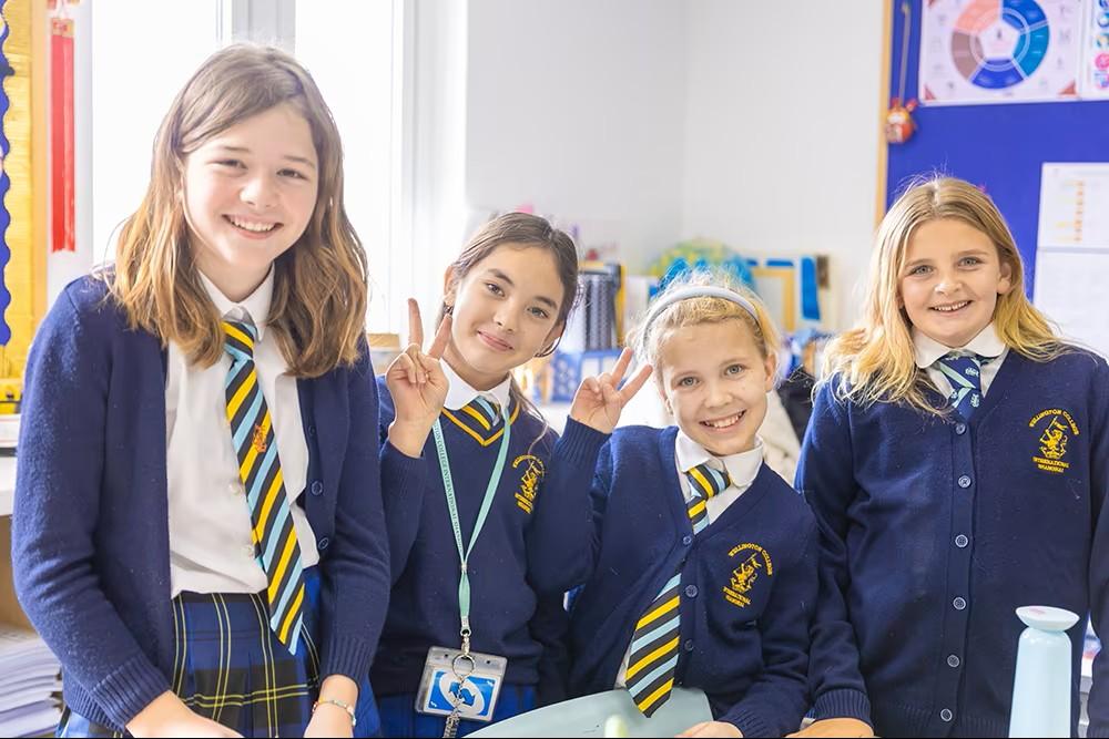 Four students from Hiba Academy Bilingual School wearing school uniforms.
